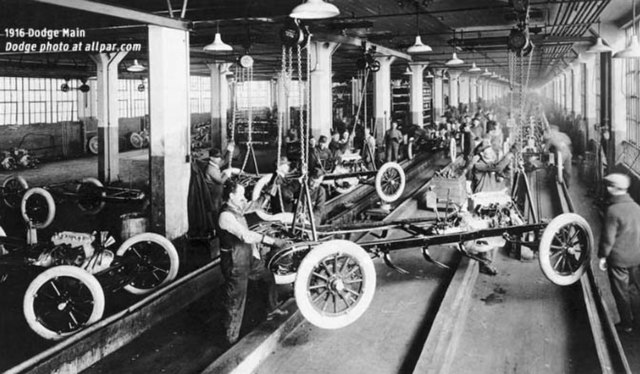 Old image of Dodge automobile factory, circa 1916. Workers are finishing chassis.